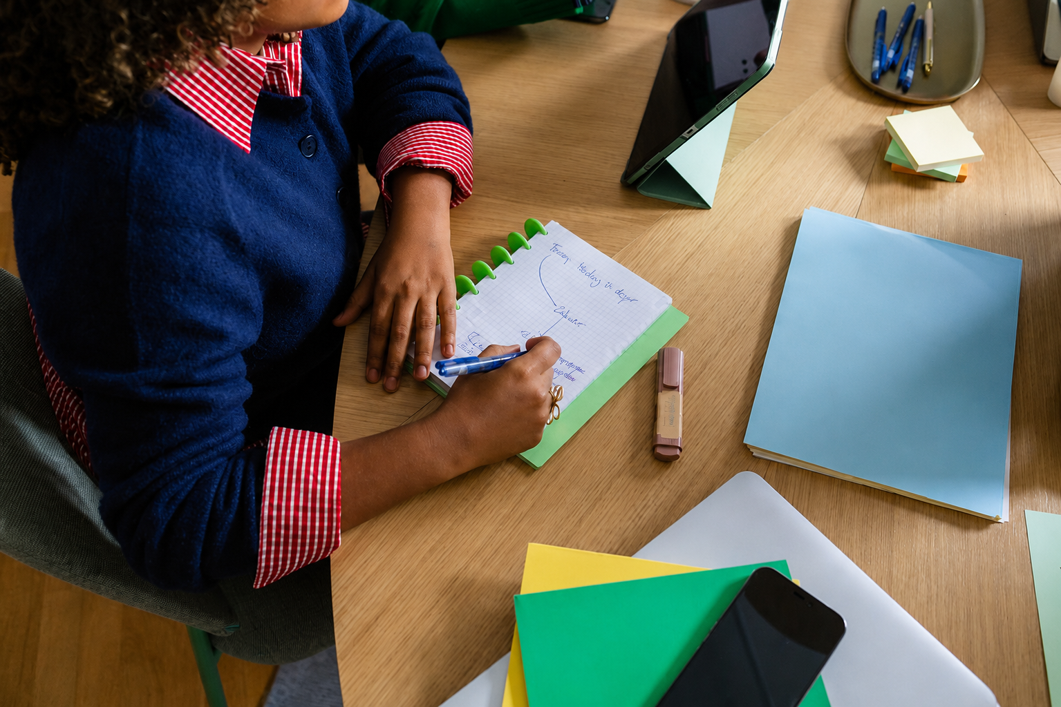 Student at desk with notebook planning for a PPT meeting